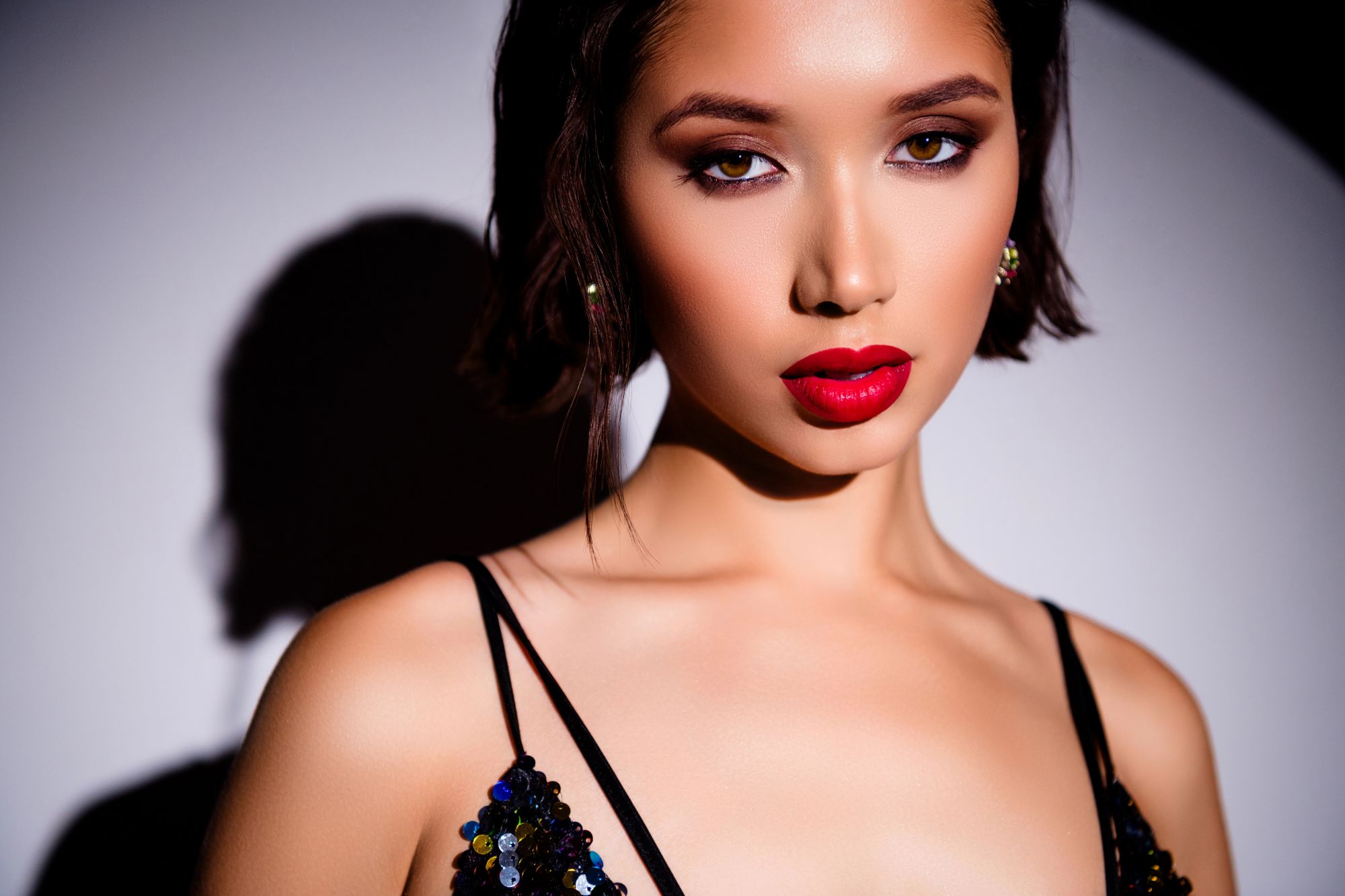 Professional fashion model in a sequined evening outfit posing in a studio