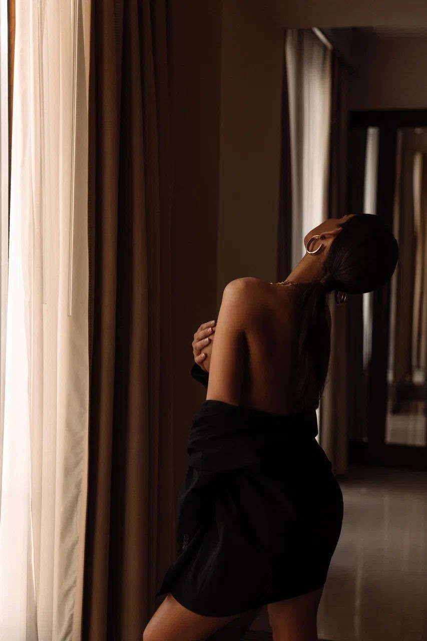 attractive lady near the curtains